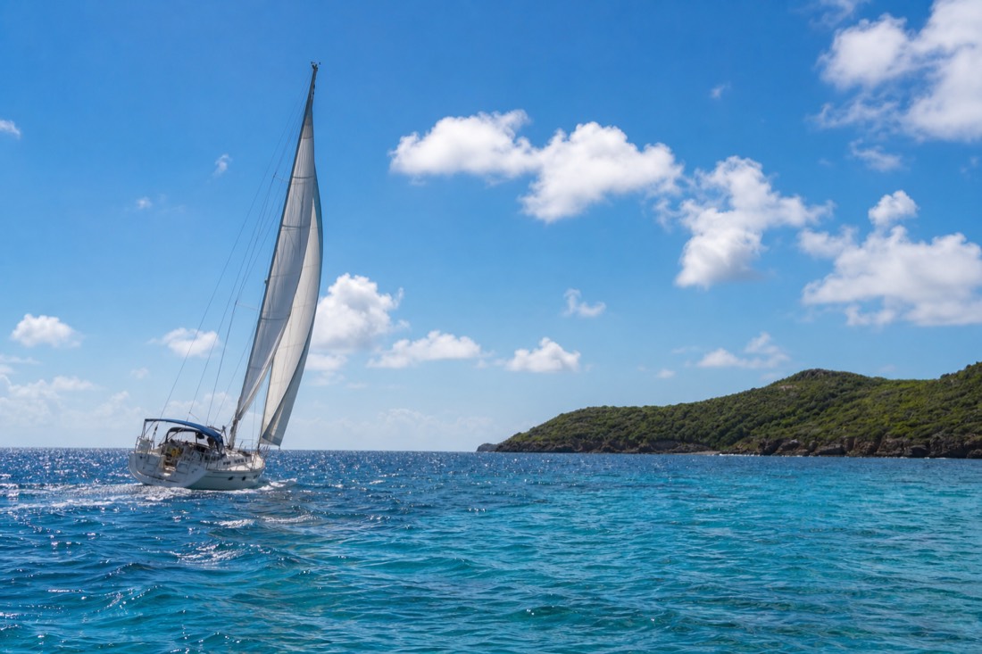 A catamaran cutting across Antigua's turquoise water